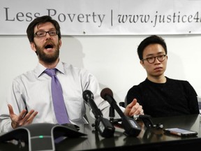 Legal Air Justice Center director Simon Sandoval-Moshenberg, left, joined by plaintiff Nurimaro Park, 26-year-old resident of Fairfax, Va., right, speaks during a news conference at the Legal Aid Justice Center in Falls Church, Va., Tuesday, Nov. 21, 2017, to announce that Park and plaintiff Jonathan Alvarenga Recinos, 19-year-old resident of Alexandria, Va., have filed a lawsuit seeking to have their Deferred Action for Childhood Arrivals, DACA, reinstated and extended for two years. (AP Photo/Carolyn Kaster)