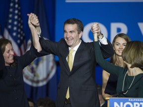 Virginia Gov.-elect Ralph Northam celebrates his election victory with his wife Pam and daughter Aubrey, right, and Dorothy McAuliffe, wife of Virginia Gov. Terry McAuliffe at the Northam For Governor election night party at George Mason University in Fairfax, Va., Tuesday, Nov. 7, 2017. (AP Photo/Cliff Owen)