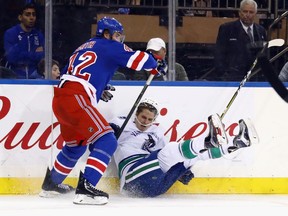 New York Rangers defenceman Brendan Smith (left) steps into Vancouver Canucks forward Jake Virtanen on Nov. 26.