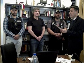 In this photo released by Argentina's Security Ministry, police detain Argentina's former Vice President Amado Boudou, second left, at his apartment in Buenos Aires, Argentina, Friday, Nov. 3, 2017. Boubou was detained on charges of illicit enrichment and money laundering. (Argentina Security Ministry via AP)