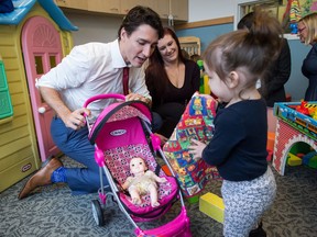 Prime Minister Justin Trudeau plays with Xiomara Nahanee, 1, during a visit to the YWCA Crabtree Corner Community Resource Centre with his wife Sophie Gregoire in the Downtown Eastside of Vancouver, B.C., on Thursday November 16, 2017. THE CANADIAN PRESS/Darryl Dyck