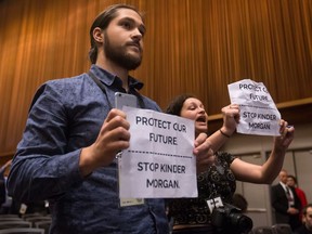 Protesters opposed to the Kinder Morgan Trans Mountain Pipeline expansion interrupt Prime Minister Justin Trudeau's news conference during the 2017 United Nations Peacekeeping Defence Ministerial conference in Vancouver, B.C., on Wednesday November 15, 2017. THE CANADIAN PRESS/Darryl Dyck