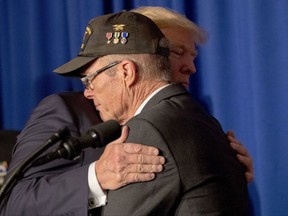 U.S. President Donald Trump hugs Vietnam veteran Max Morgan of Santa Clarita, Calif., as he becomes emotional while speaking at a veterans event at the Grand Hyatt, Friday, Nov. 10, 2017, in Danang, Vietnam. Trump is on a five-country trip through Asia traveling to Japan, South Korea, China, Vietnam and the Philippines. (AP Photo/Andrew Harnik)