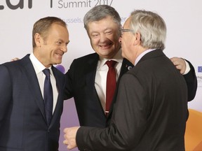 European Council President Donald Tusk, left, and European Commission President Jean-Claude Juncker, right, welcome Ukrainian President Petro Poroshenko during arrivals for an Eastern Partnership Summit in Brussels, Friday, Nov. 24, 2017. EU leaders meet with their counterparts from Armenia, Azerbaijan, Belarus, Georgia, Moldova and Ukraine for a summit in Brussels on Friday. British Prime Minister Theresa May is also due to hold separate talks. (Tatyana Zenkovich, Pool Photo via AP)