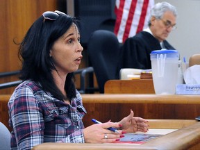 Karlyn Sizemore testifies Monday, Nov. 13, 2017 in Barre criminal court in Barre, Vt. about her being present in the Barre City Place parking lot on August 7. 2015 where she witnessed the shooting of DCF social worker Lara Sobel by Jody Herring. Sizemore, holding a state's exhibit photo of the Sobel murder scene, was testifying in Herring's sentencing hearing for the murder of Sobel in Barre and three of Herring's relatives in Berlin. Herring faces life in prison. (Stefan Hard /The Times Argus via AP, Pool)