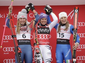 First place finisher, Viktoria Rebensburg, of Germany, center, stands on the podium with second place Mikaela Shiffrin (6), of the United States, and third place Manuela Moelgg (15), of Italy, at the women's FIS Alpine Skiing World Cup giant slalom race, Saturday, Nov. 25, 2017, in Killington, Vt. (AP Photo/Charles Krupa)