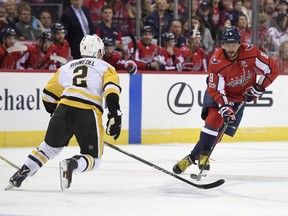Washington Capitals left wing Alex Ovechkin (8), of Russia, skates with the puck against Pittsburgh Penguins defenseman Chad Ruhwedel (2) during the first period of an NHL hockey game, Friday, Nov. 10, 2017, in Washington. (AP Photo/Nick Wass)