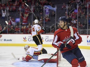 Washington Capitals center Lars Eller (20), of Denmark, reacts after his goal during the first period of an NHL hockey game as Calgary Flames goalie Mike Smith, back left, lies on the ice, Monday, Nov. 20, 2017, in Washington. (AP Photo/Nick Wass)