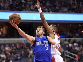 Dallas Mavericks guard J.J. Barea (5) goes to the basket against Washington Wizards guard Tim Frazier (8) during the first half of an NBA basketball game, Tuesday, Nov. 7, 2017, in Washington. (AP Photo/Nick Wass)