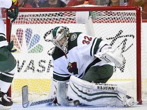 Minnesota Wild goalie Alex Stalock (32) watches the puck during the first period of an NHL hockey game against the Washington Capitals, Saturday, Nov. 18, 2017, in Washington. (AP Photo/Nick Wass)
