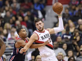 Portland Trail Blazers center Jusuf Nurkic, right, of Bosnia and Herzegovina, handles the ball against Washington Wizards forward Otto Porter Jr., left, during the first half of an NBA basketball game, Saturday, Nov. 25, 2017, in Washington. (AP Photo/Nick Wass)