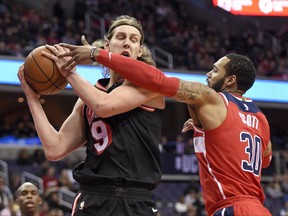 Washington Wizards forward Mike Scott (30) battles for the ball against Miami Heat center Kelly Olynyk (9) during the first half of an NBA basketball game, Friday, Nov. 17, 2017, in Washington. (AP Photo/Nick Wass)