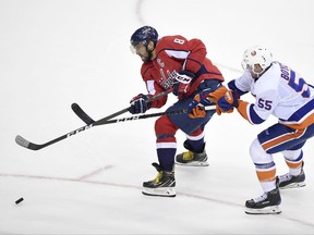 Washington Capitals left wing Alex Ovechkin (8), of Russia, chases the puck against New York Islanders defenseman Johnny Boychuk (55) during the third period of an NHL hockey game, Thursday, Nov. 2, 2017, in Washington. The Capitals won 4-3. (AP Photo/Nick Wass)