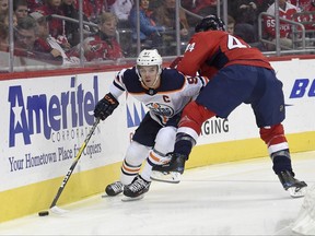 Edmonton Oilers center Connor McDavid (97) skates with the puck against Washington Capitals defenseman Brooks Orpik (44) during the first period of an NHL hockey game, Sunday, Nov. 12, 2017, in Washington. (AP Photo/Nick Wass)