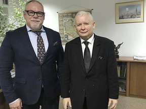 In this photo taken on Nov. 12, 2017, Poland's ruling party leader Jaroslaw Kaczynski,right, and Leszlaw Piszewski, the president of the Jewish communities of Poland, pose for a photo during a meeting in Warsaw, Poland. Warsaw prosecutors have opened an investigation Monday, Nov. 20, 2017 into expressions of xenophobia and racism voiced during a march by far-right nationalists earlier this month. (AP Photo)