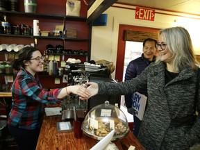Seattle Mayoral candidate Cary Moon, right, greets Haley Williams, left, co-owner of Cafe Red, as Moon stops in for coffee on Election Day, Tuesday, Nov. 7, 2017, in Seattle. More than 90 years after Seattle elected Bertha Knight Landes as mayor, voters on Tuesday will elect a female mayor for the second time. Voters are choosing between Moon, an urban planner, and former U.S. Attorney Jenny Durkan to lead a city dealing with the benefits and problems of an economy booming for some more than others as e-commerce giant Amazon expands. (AP Photo/Ted S. Warren)