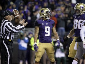 Washington running back Myles Gaskin (9) stands in the end zone after he scored his first touchdown in the first half of an NCAA college football game against Washington State, Saturday, Nov. 25, 2017, in Seattle. (AP Photo/Ted S. Warren)