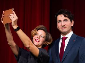 Kathleen Payette, managing director of Montreal's Grévin Museum, takes a selfie with the wax version of Justin Trudeau.