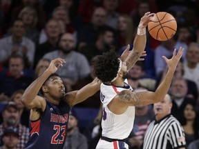 Howard forward Jalen Jones (23) and Gonzaga guard Josh Perkins go after the ball during the first half of an NCAA college basketball game in Spokane, Wash., Tuesday, Nov. 14, 2017. (AP Photo/Young Kwak)
