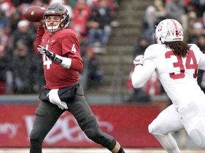 Washington State quarterback Luke Falk (4) throws a pass as he is chased by Stanford linebacker Peter Kalambayi (34) during the first half of an NCAA college football game in Pullman, Wash., Saturday, Nov. 4, 2017. (AP Photo/Young Kwak)