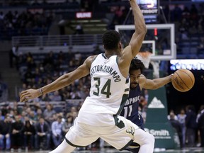 Memphis Grizzlies' Mike Conley (11) drives against Milwaukee Bucks' Giannis Antetokounmpo (34) during the first half of an NBA basketball game Monday, Nov. 13, 2017, in Milwaukee. (AP Photo/Aaron Gash)
