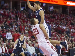 Yale's Alex Copeland (3) fouls Wisconsin's Kobe King (23) during the first half of an NCAA college basketball game Sunday, Nov. 12, 2017, in Madison, Wis. (AP Photo/Andy Manis)