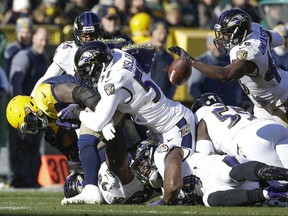 Green Bay Packers' Devante Mays fumbles the ball during the first half of an NFL football game against the Baltimore Ravens Sunday, Nov. 19, 2017, in Green Bay, Wis. The Ravens recovered the ball. (AP Photo/Jeffrey Phelps)