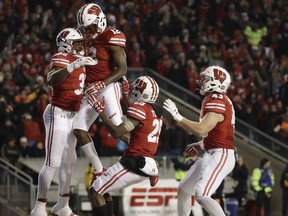 Wisconsin's Leon Jacobs is congratulated after running back a fumble for a touchdown during the second half of an NCAA college football game against Iowa Saturday, Nov. 11, 2017, in Madison, Wis. (AP Photo/Morry Gash)