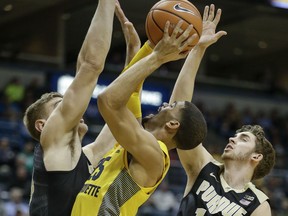 Marquette's Haanif Cheatham has his shot blocked by Purdue's Matt Haarms during the first half of an NCAA college basketball game Tuesday, Nov. 14, 2017, in Milwaukee. (AP Photo/Tom Lynn)
