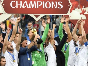 FILE - In this file photo dated Sunday July 2, 2017, Germany coach Joachim Loew holds the trophy after Germany won 1-0 in the Confederations Cup final soccer match between Chile and Germany, at the St.Petersburg Stadium, Russia.  More worldwide soccer tournaments involving even more national teams could be coming to every odd-numbered year, according to officials of the UEFA-led Global Nations League project, Friday Nov. 3, 2017, which may replace the Confederation Cup. (AP Photo/Martin Meissner, FILE)