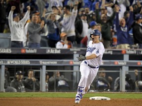 Los Angeles Dodgers' Joc Pederson celebrates his home run off against the Houston Astros during the seventh inning of Game 6 of baseball's World Series Tuesday, Oct. 31, 2017, in Los Angeles. (AP Photo/Mark J. Terrill)