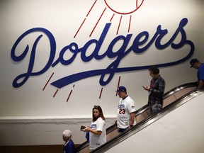 Fans make their way around Dodgers Stadium before Game 6 of baseball's World Series between the Houston Astros and the Los Angeles Dodgers Tuesday, Oct. 31, 2017, in Los Angeles. (AP Photo/Jae C. Hong)