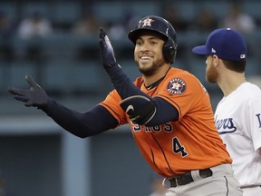 Houston Astros' George Springer reacts after hitting a double during the first inning of Game 7 of baseball's World Series against the Los Angeles Dodgers Wednesday, Nov. 1, 2017, in Los Angeles. (AP Photo/David J. Phillip)