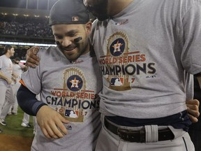 Houston Astros' Jose Altuve and Marwin Gonzalez celebrate after Game 7 of baseball's World Series against the Los Angeles Dodgers Wednesday, Nov. 1, 2017, in Los Angeles. The Astros won 5-1 to win the series 4-3. (AP Photo/David J. Phillip)