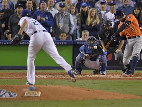 Houston Astros' George Springer, right, hits a two-run home run off Los Angeles Dodgers starting pitcher Yu Darvish, of Japan, during the second inning of Game 7 of baseball's World Series Wednesday, Nov. 1, 2017, in Los Angeles. (AP Photo/Mark J. Terrill)