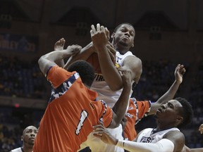 West Virginia forward Sagaba Konate (50) grabs a rebound from Morgan State guard LaPri McCray-Pace (1) during the first half of an NCAA college basketball game, Saturday, Nov. 18, 2017, in Morgantown, W.Va. (AP Photo/Raymond Thompson)