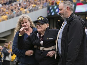 Retired Navy Lt. Jim Downing, a Pearl Harbor survivor, is honored during the first half of an NCAA college football game in Morgantown, W.Va., Saturday, Nov. 4, 2017. (AP Photo/Walter Scriptunas II)