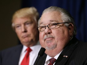 FILE - In this Aug. 25, 2016, file photo, Sam Clovis speaks during a news conference as then-Republican presidential candidate Donald Trump, left, watches before a campaign rally in Dubuque, Iowa. Clovis, a former Trump campaign official who has been linked to the investigation by special counsel Robert Mueller, has withdrawn his nomination for an Agriculture post. (AP Photo/Charlie Neibergall)