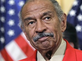 File - In this April 4, 2011 file photo, Rep. John Conyers, D-Mich., the ranking member of the House Judiciary Committee, listens during a news conference on Capitol Hill in Washington.  Top House Democrat Nancy Pelosi says Conyers, facing sexual misconduct allegations, should resign. (AP Photo/J. Scott Applewhite)