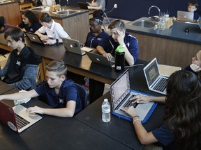 In this Nov. 16, 2017, photo, students work on computers in a freshman biology class at Lake Mead Christian Academy in Henderson, Nev. Standardized tests are a given in public schools, and they're mandatory for Nevada private schools participating in the state's budding school-choice program. Schools in Nevada's voucher-like program for low-income families are required to begin submitting test results next year and Nevada is trying figuring out what to do with that information (AP Photo/John Locher)
