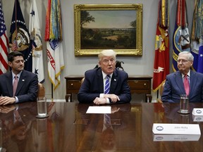 FILE - In this Sept. 5, 2017, file photo, House Speaker Paul Ryan, R-Wis., left, and Senate Majority Leader Mitch McConnell, R-Ky., right, listen as President Donald Trump speaks during a meeting with Congressional leaders and administration officials on tax reform, in the Roosevelt Room of the White House in Washington. Taxes, spending, immigration, and more, top a daunting agenda when Congress returns to Washington on Monday, Nov. 27, 2017. It's a critically important moment for the president and his GOP allies controlling Congress, who are still reaching for their first major Capitol Hill win. Tax cuts would fit the bill. (AP Photo/Evan Vucci, File)