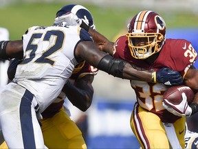 FILE - In this Sept. 17, 2017 file photo, Washington Redskins running back Samaje Perine (32) in action defended by Los Angeles Rams linebacker Alec Ogletree (52) during the second half of an NFL football game in Los Angeles. (AP Photo/Kelvin Kuo)