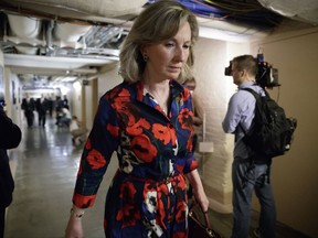 FILE - In this March 28, 2017, file photo, Rep. Barbara Comstock, R-Va., walks at the Capitol, in Washington. Amid a daily deluge of stories about harassment in the workplace, female members of Congress detailed incidents of sexual misconduct involving current lawmakers at a House hearing on how to prevent such abuse. Comstock said she was recently told about a staffer who quit her job after a lawmaker asked her to bring work material to his house, then exposed himself. (AP Photo/J. Scott Applewhite, File)