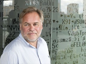 FILE - In this July 1, 2017, file photo, Eugene Kaspersky, the Russian antivirus programs developer and chief executive of Russia's Kaspersky Lab, stands in front of a window decorated with programming code's symbols at his company's headquarters in Moscow, Russia. A top homeland security official says computer systems at 15 percent of U.S. government agencies were running Kaspersky Lab software that's been banned because of concerns about the company's ties to the Kremlin and Russian spy operations. (AP Photo/Pavel Golovkin, File)