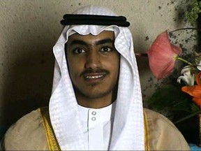 In this image from video released by the CIA, Hamza bin Laden is seen as an adult at his wedding. The never-before-seen video of Osama bin Laden's son and potential successor was released Nov. 1, 2017, by the CIA in a trove of material recovered during the May 2011 raid that killed the al-Qaida leader at his compound in Pakistan. The one hourlong video shows Hamza bin Laden, sporting a trimmed mustache but no beard, at his wedding. He is sitting on a carpet with other men. (CIA via AP)