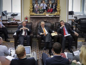 In this Nov. 8, 2017, photo, from left, Sen. Tim Kaine, D-Va., Senate Minority Leader Chuck Schumer, D-N.Y., and Sen. Mark Warner, D-Va., speak informally on tax reform and the elections with reporters in the Senate Press Gallery at the Capitol in Washington. It's an article of faith among Republicans that the GOP's electoral fortunes next year hinge on whether they succeed in their longstanding dream to redraft the nation's complex, inefficient tax code. (AP Photo/J. Scott Applewhite)