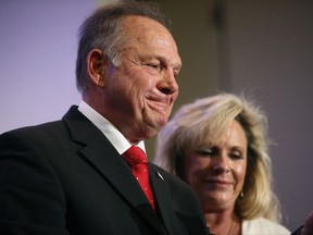 In this Nov. 16, 2017, photo, former Alabama Chief Justice and U.S. Senate candidate Roy Moore speaks at a news conference in Birmingham, Ala., with his wife Kayla Moore, right. A sex scandal has relegated Moore's hard-line positions on LGBT issues to the background in Alabama's turbulent Senate race even as religious activists blame the "LGBT mafia" and "homosexualist gay terrorism" for his precarious political plight. (AP Photo/Brynn Anderson)