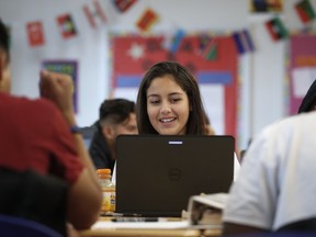 Zayra Granados, 17, from El Salvador, works with the civics computer game iCivics during Phoebe Sherman's 11th grade social studies class at Roosevelt High School's International Academy in Washington, Thursday, Nov. 16, 2017. Supreme Court Justice Sonia Sotomayor and former Supreme Court Justice Sandra Day O'Connor are backing iCivics that is now being translated into Spanish. (AP Photo/Carolyn Kaster)