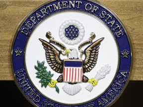 FILE - This Jan. 25, 2010, file photo, shows the United States Department of State seal on a podium at the State Department in Washington. America's registered child sex offenders will now have to use passports identifying them for their past crimes when traveling overseas. The State Department said Wednesday it would begin revoking passports of registered child sex offenders and requiring them to apply for a new one that carries a "unique identifier" of their status.  (AP Photo/Alex Brandon, File)