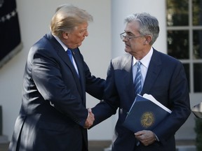 FILE - In this Nov. 2, 2017, file photo, President Donald Trump shakes hands with Federal Reserve board member Jerome Powell after announcing him as his nominee for the next chair of the Federal Reserve, in the Rose Garden of the White House in Washington. Trump has bashed George W. Bush, and the Bush family hasn't shied from hitting back. Despite that ill will, the White House has found it advisable to draw on dozens of veterans from the last Republican administration for their expertise in running the government. (AP Photo/Alex Brandon, File)